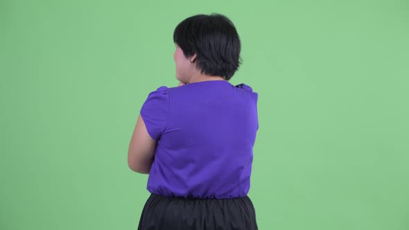 Rear View of Young Overweight Asian Woman Thinking and Waiting alt