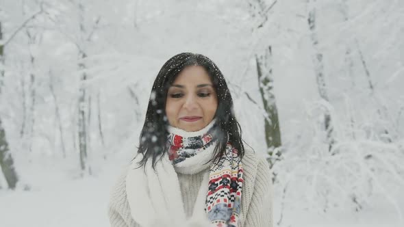 Woman Who Walks in a Snow-Covered Forest and Clapping in the Palm alt