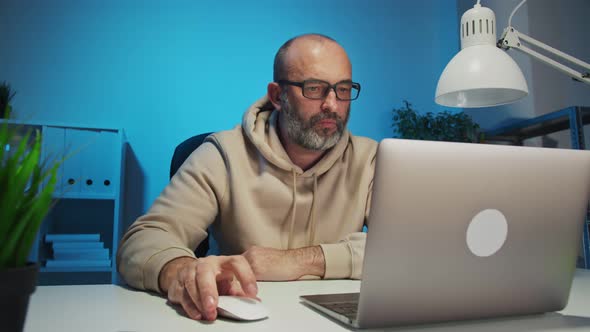 Businessman Working with Laptop at Home Office alt
