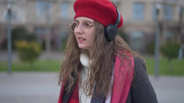 Medium Shot Portrait of Young Charming Elegant Caucasian Woman in Eyeglasses and Red Beret Enjoying alt