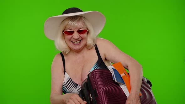 Elderly Grandmother Tourist Waving Hand Hi Hello Welcome Woman with Luggage Passport Tickets alt