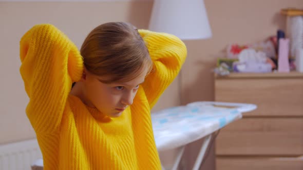 Girl Tying Her Hair In A Ponytail alt