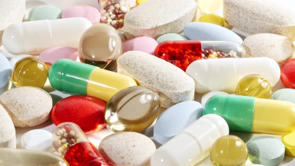 Colorful Medical Pills Rotating Closeup on White Background alt