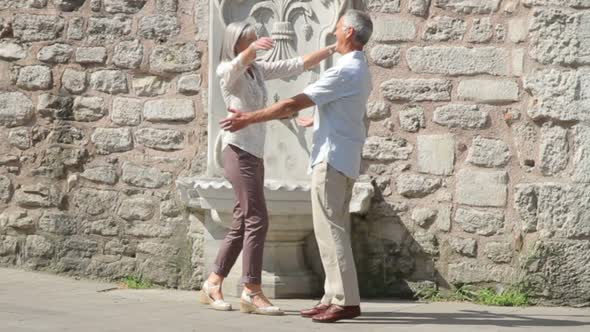 Senior couple dancing on romantic holiday alt