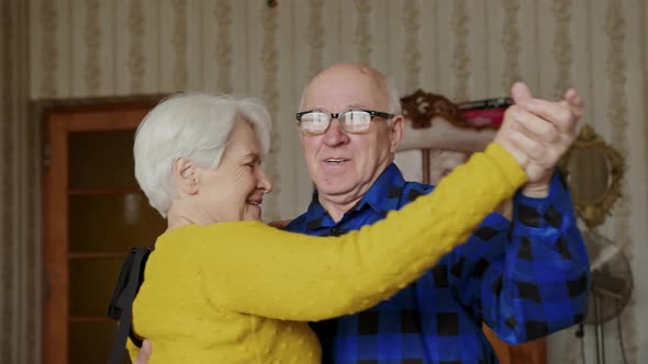 Mature Caucasian Married Couple Dance in the Living Room Senior People Support Concept alt