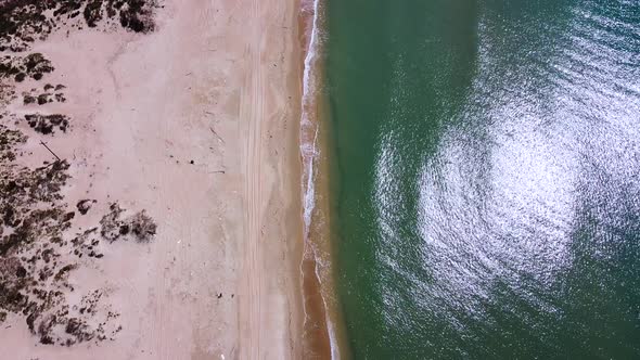 Seascape, calm sea, sandy beach, aerial view. Beautiful sea background