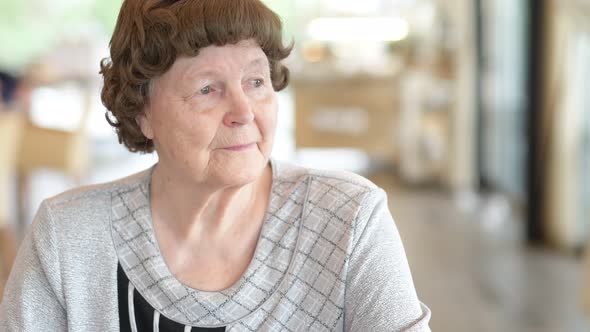 Happy Senior Woman Relaxing At The Coffee Shop alt