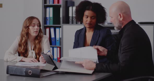 Businessman Discussing with Coworkers in Office alt