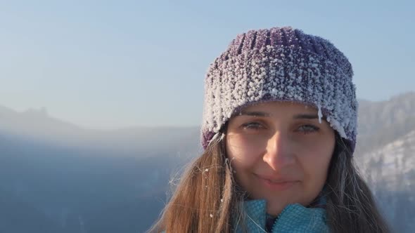 Portrait of a Young Happy Woman in the Mountains