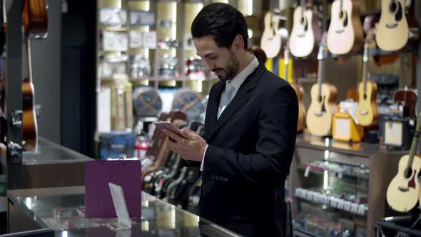Young man paying with QR code by smartphone contactless alt