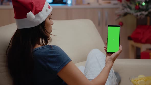 Woman Vertically Holding Smartphone with Green Screen alt