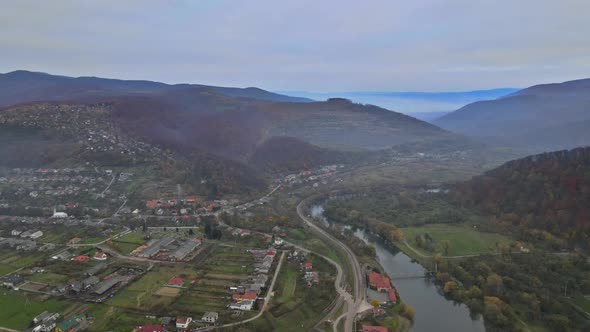 Aerial view in the mountain valley autumn landscape with small village alt