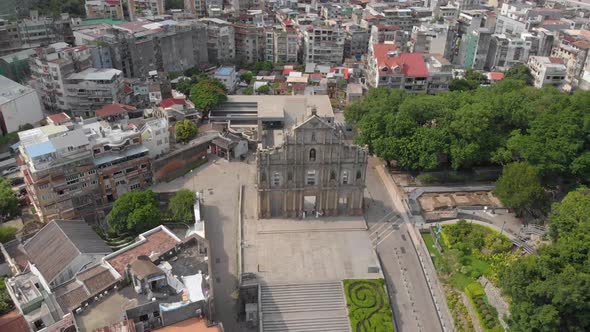 Tilt reveal aerial view of famous Ruins of Saint Paul's, Macau on sunny evening alt