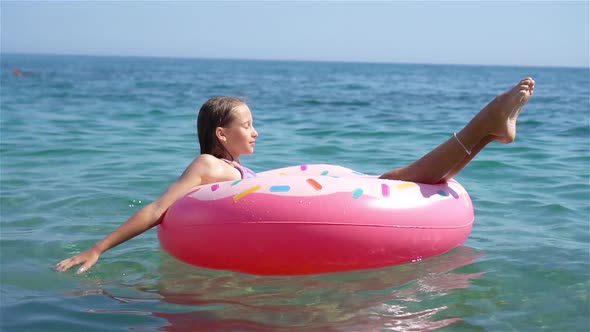 Adorable Girl on Inflatable Air Mattress in the Sea
