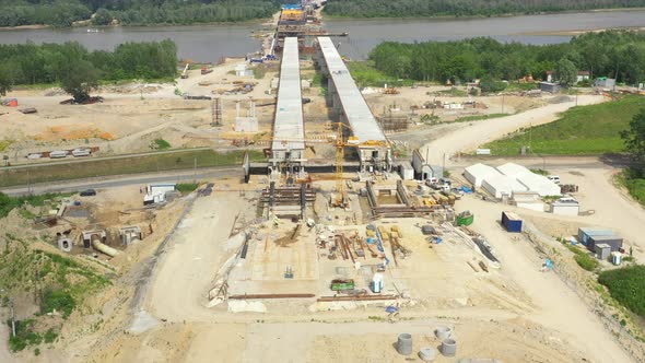 Aerial view of the construction of the bridge and the highway passing alt