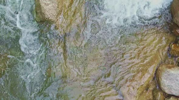 Close Upper View Mountain River Water Swirls Among Boulders alt