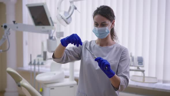 Female Dentist Opening Carpool Syringe in Slow Motion Looking at Needle alt