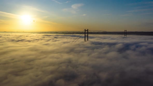 Aerial hyper-lapse drone flight towards the fog on the Humber surrounding the Humber Bridge alt