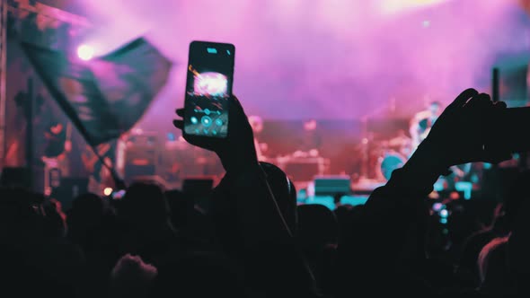 People Filming Rock Concert on Smartphones Silhouettes Crowd of Fans Dancing alt