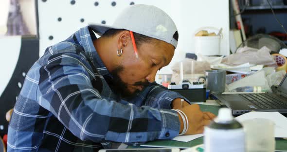 Man Drawing Design on Paper 4k alt