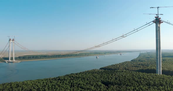 Approaching Ships Across Danube River With Braila-Tulcea New Bridge In Eastern Romania. Wide Shot alt