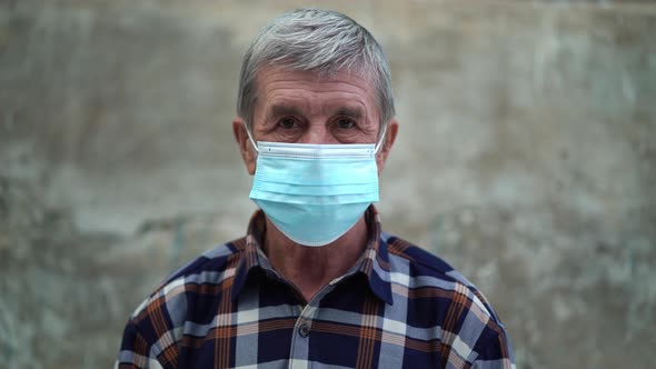 An Old Man Is Using Face Mask for Protect From Virus Against the Second Wave Quarantine Coronavirus alt