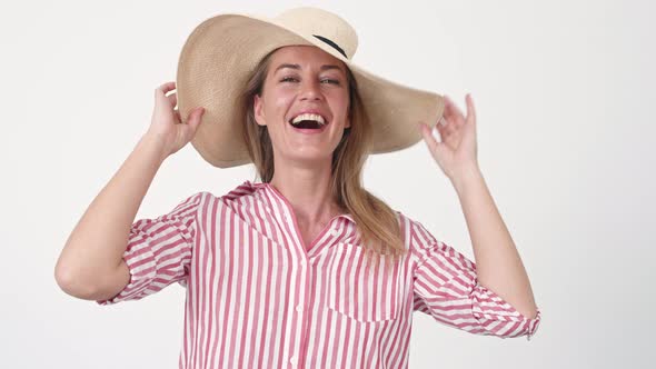 Woman Putting on Large Hat