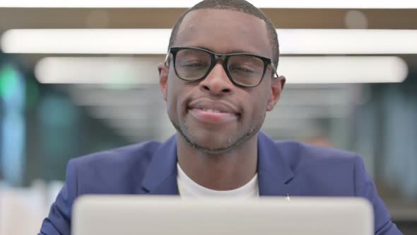 African Businessman with Laptop Smiling at Camera alt