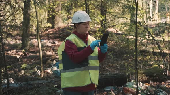 Woman Environmentalist in Workwear and Helmet Record Offense  Forest Pollution