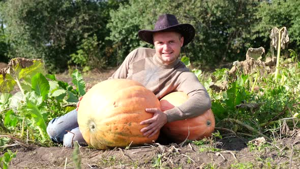 Farmer with Pumpkins Young Farmer with Pumpkins Hugging a Big Pumpkin alt