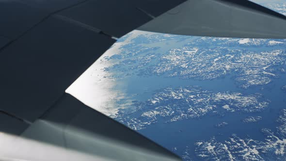 Airplane Wing In Shot Of Ice Covered Greenland alt