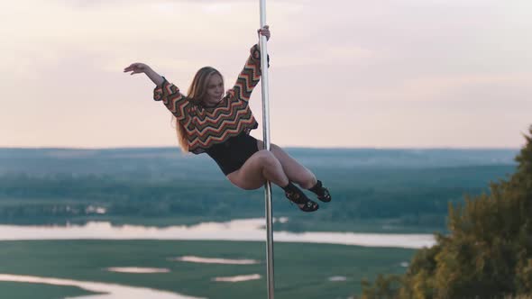 Pole Dance on Nature - Woman in Colorful Knitted Crop Top Dancing on the Pole alt