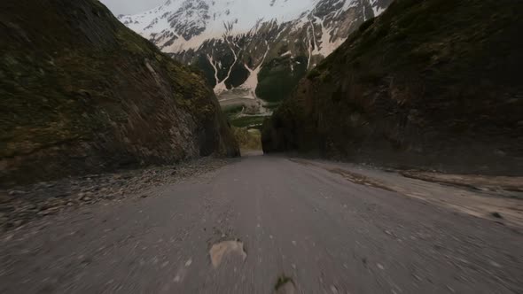 FPV Drone Shot Low Fast Flying Over Stone Valley and Through Rocky Gates alt