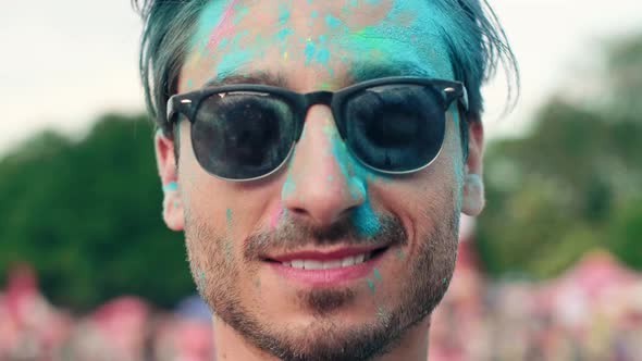 Man in holi colors at the festival alt