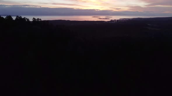 A drone video tilting up to reveal a sunrise over the ocean. Located in Parksville, Vancouver Island alt