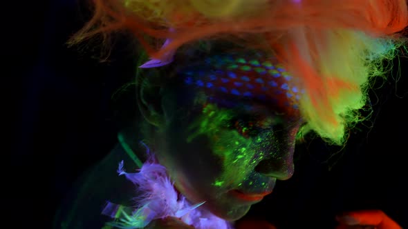 Sexually and Creative Image with Fluorescent Paints on Female Skin Woman in Uv Light alt