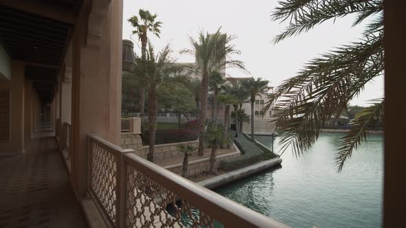 Reveal of Water Canal Surrounded By Bars and Palm Trees in Dubai Luxury Hotel Resort alt