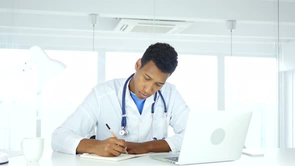 African Doctor Writing Medical Reports of Patient, Medicine alt
