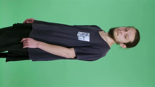 A Man Looks at the Camera Turns Sideways and Shakes His Head Negatively Pointing at Something with alt