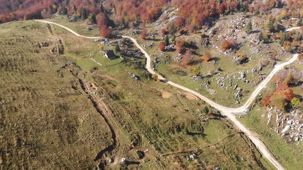 Flying over pasture in Slovenia. Aerial shot of rural roads. alt