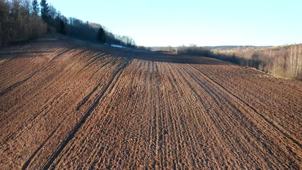 AERIAL: Plowed Farm Area on a Sunny Day in Eastern Europe alt
