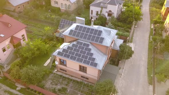 Aerial view of a private house with solar panels on roof. Photo voltaic system for renewable energy alt