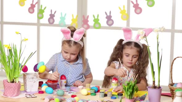 Happy Children Wearing Bunny Ears Painting Eggs on Easter Day