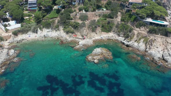 Drone View of Rocky Beach in Small Blue Bay alt