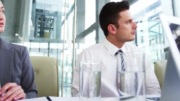 Businessman giving a presentation in a meeting alt
