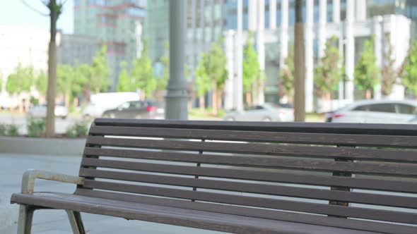 Man Coming Sitting on Bench and Opening Laptop alt