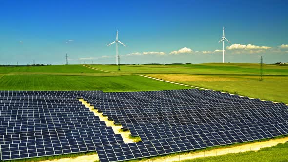 Solar panels, wind turbines and green field, view from above, Poland alt