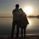 Man and Woman Standing Near the Sea Shore at Dawn - VideoHive Item for Sale