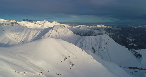 Imazing Aerial Shot of Snowy Peak in Georgian Mountains. Slowmotion Drone Video
