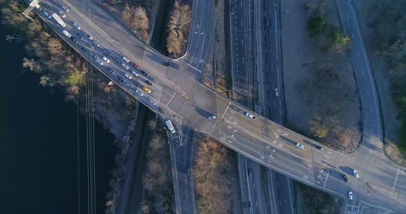 Top Down View of a Highway Junction and Train Tracks by River alt